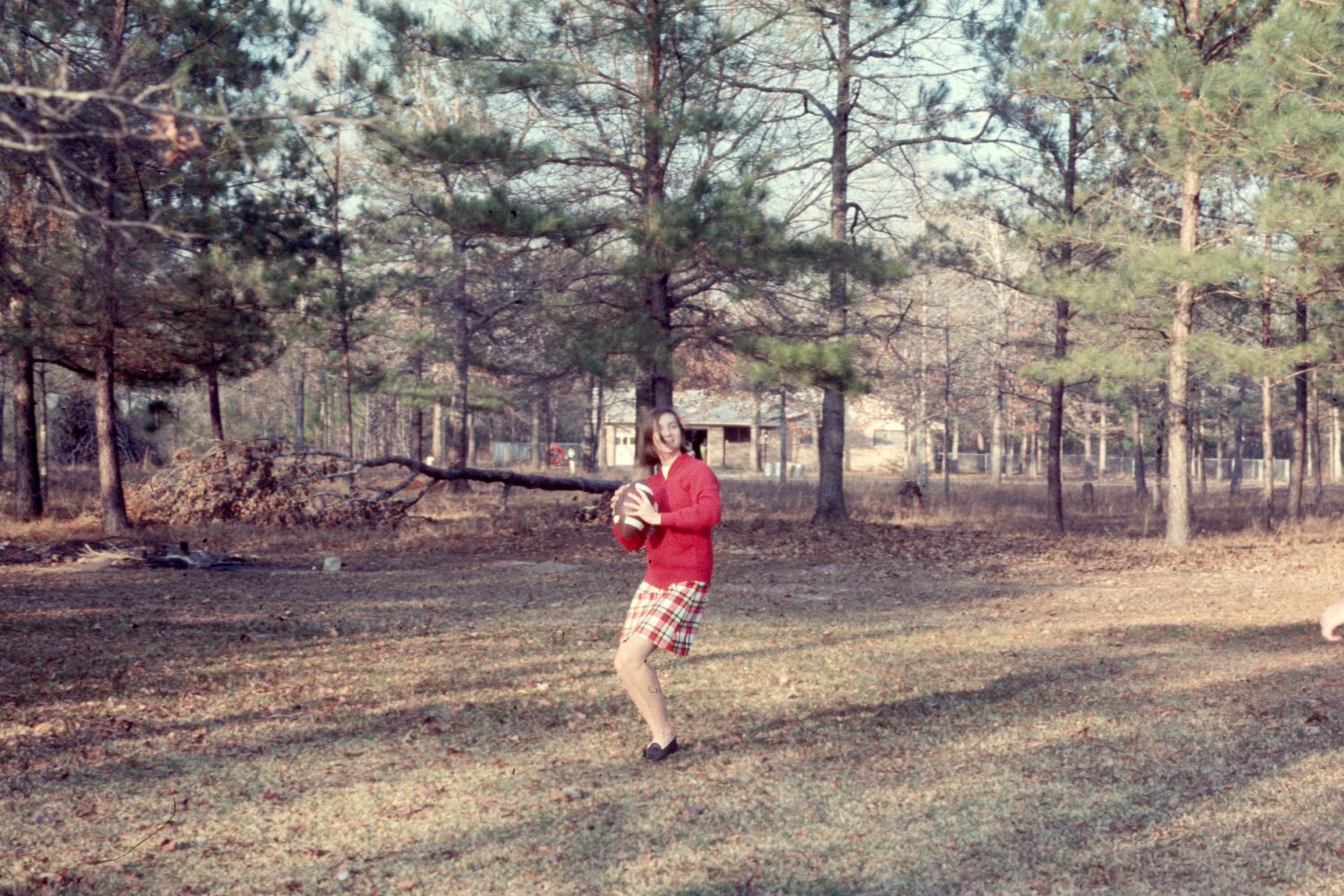 Always the athlete - Linda in the Bevil Oaks backyard at Thankgiving. A few years later she would build a house where the rrees are behind her.