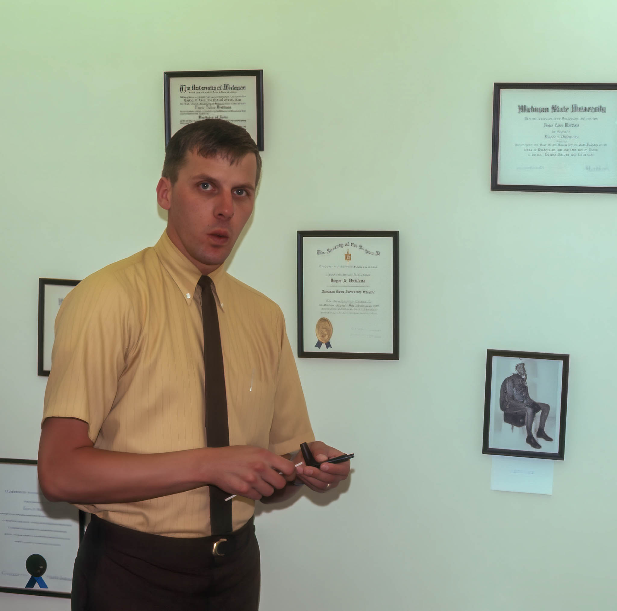 Roger stoking his pipe. Notice the photo of him in a 50s era pressure suit from Wright Patterson AFB.